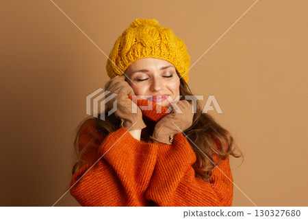 Content Woman Embracing Cozy Autumn Knitwear Content Woman Embracing Cozy Autumn Knitwear 130327680