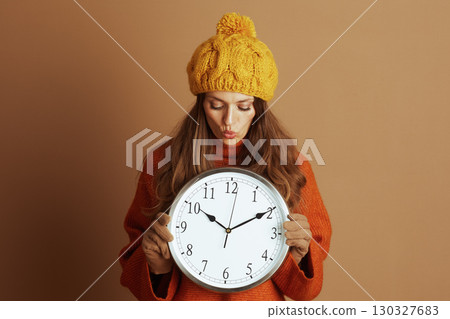 Anticipating Time: Woman in Cozy Fall Fashion Anticipating Time: Woman in Cozy Fall Fashion 130327683