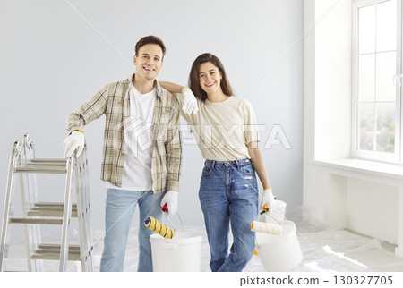 Happy Couple Painting Walls Together During Home Renovation 130327705