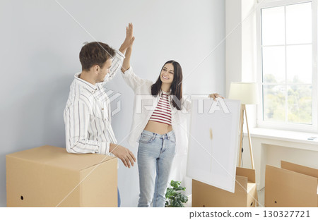 Married Couple Giving High Five During Relocation 130327721