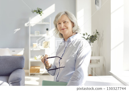 Positive Elderly Woman Smiling At Home 130327744
