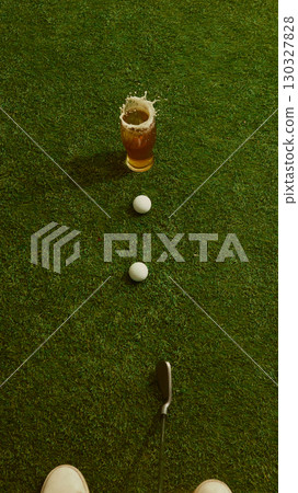 Beer glass splashing with golf club and balls on grass energetic dynamic scene Beer glass splashing with golf club and balls on grass energetic dynamic scene 130327828