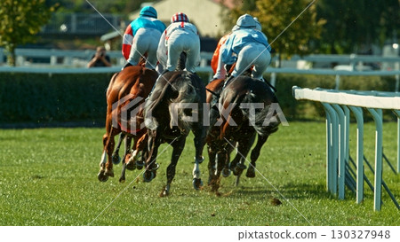 Horse racing outdoor derby with jockeys heading to finish line. Outdoor sport and competition. Horse racing outdoor derby with jockeys heading to finish line. Outdoor sport and competition. 130327948