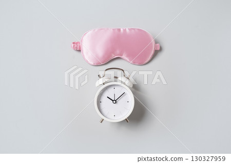 Pink sleeping mask, watch and vitamins capsules. Concept of sleep, health care. Pink sleeping mask, watch and vitamins capsules. Concept of sleep, health care. 130327959