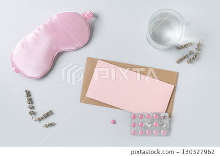 Pink sleeping mask, watch and vitamins capsules. Concept of daily routine. Pink sleeping mask, watch and vitamins capsules. Concept of daily routine. 130327962
