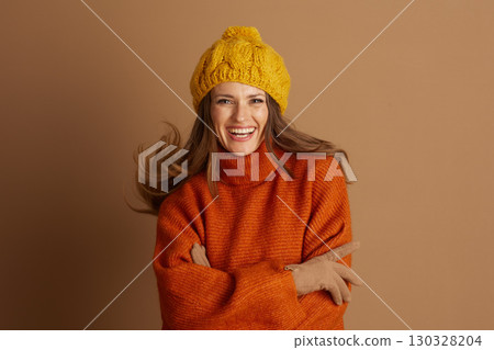 Vibrant Woman in Cable Knit Beanie and Orange Sweater 130328204