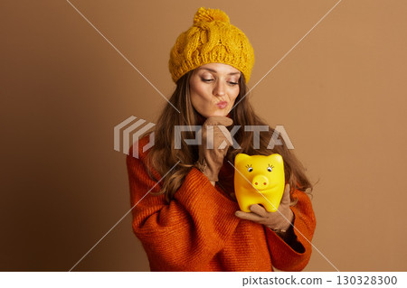 Contemplative Woman Pondering Piggy Bank Savings 130328300