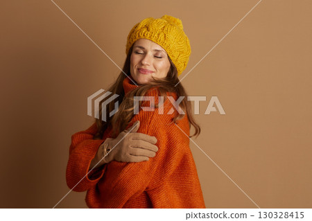 Peaceful Woman in Oversized Knit Sweater & Beanie 130328415