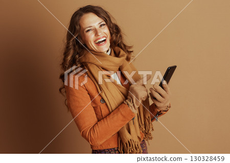 Happy Woman Pointing and Laughing at Her Smartphone Happy Woman Pointing and Laughing at Her Smartphone 130328459