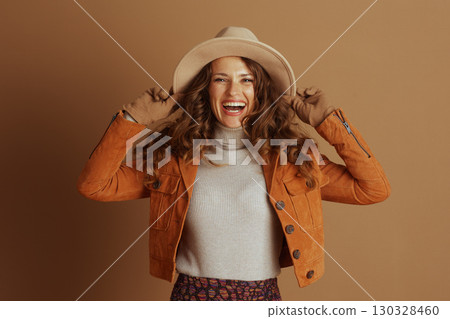 Confident Woman in Fedora Hat and Suede Jacket Confident Woman in Fedora Hat and Suede Jacket 130328460