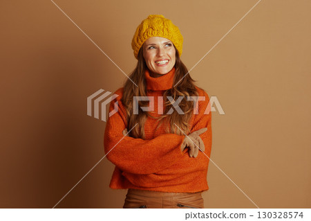 Smiling Woman in Autumn Knitwear with Crossed Arms 130328574
