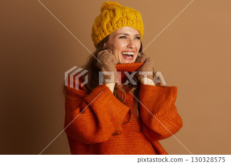 Cheerful Woman in Warm Cable-Knit Autumn Style Cheerful Woman in Warm Cable-Knit Autumn Style 130328575