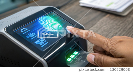 Fingerprint scanner with digital verification interface on wooden desk 130329008