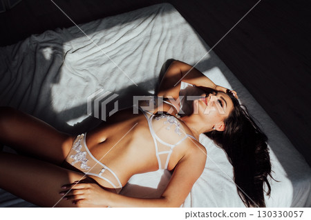 Fashionable photo of young lady wearing white lingerie, amazing body. Fashionable photo of young lady wearing white lingerie, amazing body. 130330057