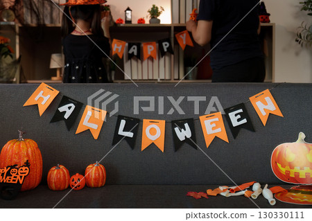 Halloween Celebration: Family Decorating with Banners and Pumpkins 130330111