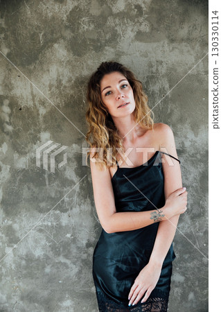 Happy Woman in Black Long Dress. Fashion Model in Evening Gown with Slit over White Background. 130330114