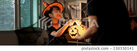 Halloween Joy: Girl Presenting Pumpkin Lantern to Parent Halloween Joy: Girl Presenting Pumpkin Lantern to Parent 130330141