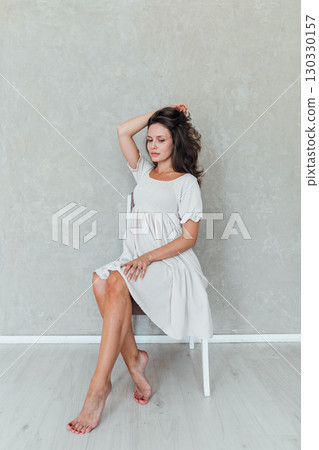 Portrait of a beautiful woman in a light summer dress 130330157