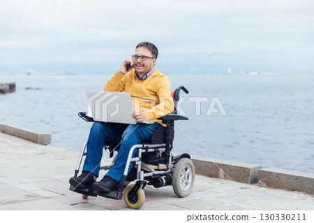 businessman on a wheelchair at a window uses smartphone 4k businessman on a wheelchair at a window uses smartphone 4k 130330211