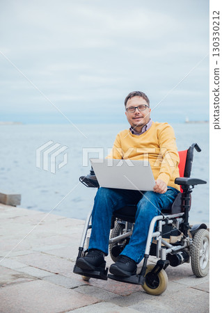 businessman on a wheelchair at a window uses smartphone 4k businessman on a wheelchair at a window uses smartphone 4k 130330212