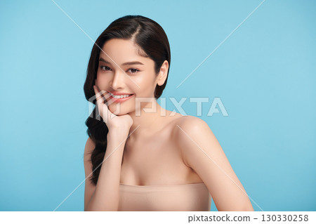 Beautiful Young transgender woman with clean fresh skin on blue background, Face care, Facial treatment, Cosmetology, beauty and spa, transgender women portrait. 130330258