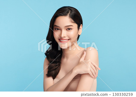 Beautiful Young transgender woman with clean fresh skin on blue background, Face care, Facial treatment, Cosmetology, beauty and spa, transgender women portrait. 130330259