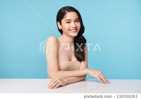 Beautiful Young transgender woman with clean fresh skin on blue background, Face care, Facial treatment, Cosmetology, beauty and spa, transgender women portrait. 130330261
