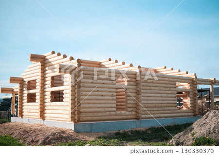 Wooden house building, house made of rounded logs, ecological house Wooden house building, house made of rounded logs, ecological house 130330370