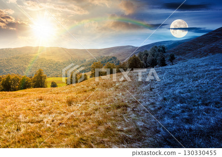 calm autumn day in mountains. day and night time change concept. deciduous trees on the grassy hills of the ridge. alpine scenery in fall season under with sun and moon. beauty in nature concept calm autumn day in mountains. day and night time change concept. deciduous trees on the grassy hills of the ridge. alpine scenery in fall season under with sun and moon. beauty in nature concept 130330455