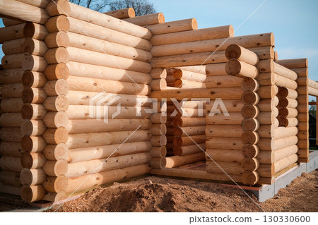 Wooden house building, house made of rounded logs, ecological house Wooden house building, house made of rounded logs, ecological house 130330600