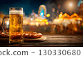 A glass of beer and pretzels on a wooden table. Oktoberfest festival lights in the background. Celebratory atmosphere in Bavaria, Germany. 130330680