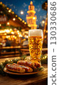 A glass of beer next to a plate of sausages on a wooden table. Festive lights and decorations in the background create a lively atmosphere typical of Oktoberfest in Bavaria, Germany. 130330686