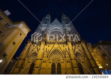 St. Vitus Cathedral illuminating Prague Castle at night in Czechia 130330864