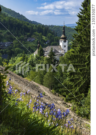 Spania Dolina church rising above lush green valley in Slovakia Spania Dolina church rising above lush green valley in Slovakia 130330877