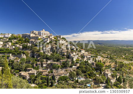Gordes dominating the landscape in Provence, France, under a blue sky Gordes dominating the landscape in Provence, France, under a blue sky 130330937