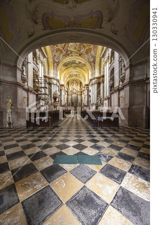 Interior of Jasov Monastery Church showcasing baroque architecture and checkered floor Interior of Jasov Monastery Church showcasing baroque architecture and checkered floor 130330941