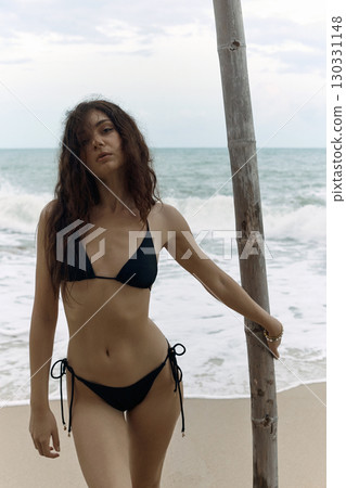 Beautiful young woman on the beach. pretty Sexy girl in Bikini 130331148