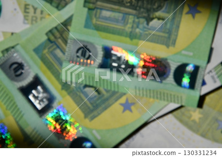 Euro bills blurry background showcasing intricate details and vibrant holographic aspects in close proximity during daytime Euro bills blurry background showcasing intricate details and vibrant holographic aspects in close proximity during daytime 130331234