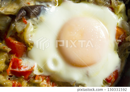 Cooked vegetables with poached egg 130331592