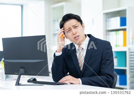 Middle-aged businessman worried in the office 130331762