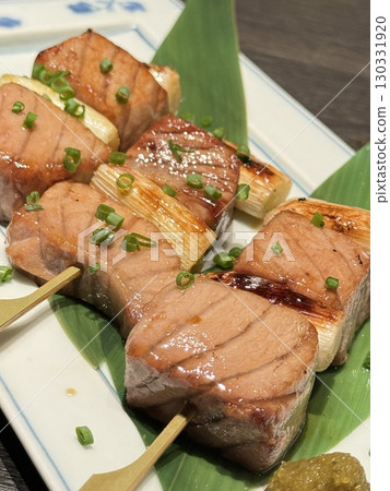 Savory grilled meat and green onion skewers Savory grilled meat and green onion skewers 130331920