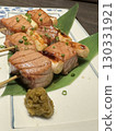 Savory grilled meat and green onion skewers 130331921