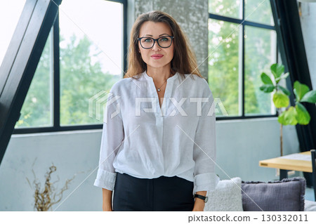 Portrait of middle-aged confident business woman looking at camera Portrait of middle-aged confident business woman looking at camera 130332011