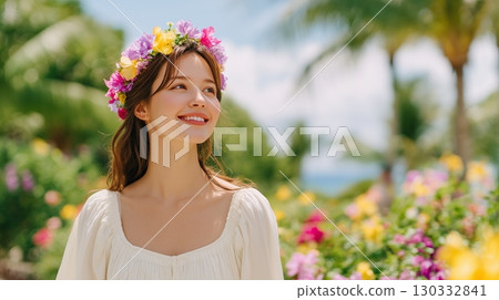 A smiling woman surrounded by hibiscus flowers on a tropical beach 130332841