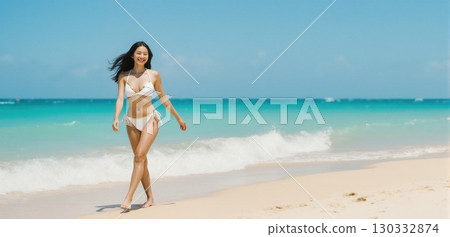 Young woman walking gracefully along tropical beach shoreline in summer vacation mood 130332874