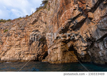 Rocky cliffs rise dramatically above the sea water, Montenegro Rocky cliffs rise dramatically above the sea water, Montenegro 130333489