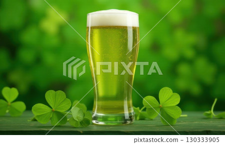 Glass of green foamy irish beer stands on green grassy clover background. St. Patrick Day 130333905