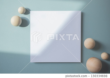 Empty white blank greeting or invitation card with wooden ball on blue background. Mock up presentation. Empty white blank greeting or invitation card with wooden ball on blue background. Mock up presentation. 130334698