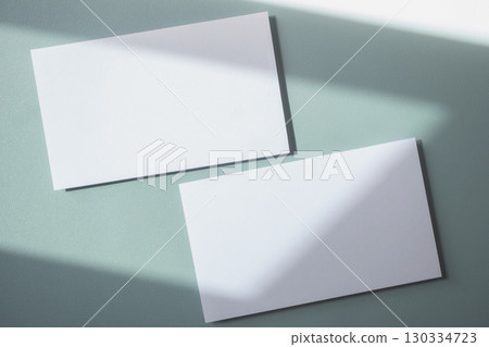 Empty white blank greeting or invitation card on blue background. Mock up presentation. 130334723