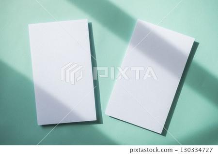 Empty white blank greeting or invitation card on blue background. Mock up presentation. 130334727